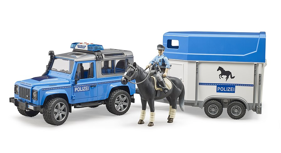 BRUDER  VEICOLO DELLA POLIZIA LAND ROVER DEFENDER CON RIMORCHIO, CAVALLO E UFFICALE DI POLIZIA 02588